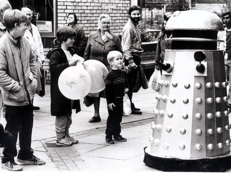 Dr Who remained on the television throughout the 80s., Children are surprised to find a Dalek on The Moor, Sheffield in October 1985