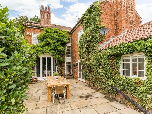 The walled gardens to the rear enjoy privacy afforded by the variety of mature trees and shrubbery.