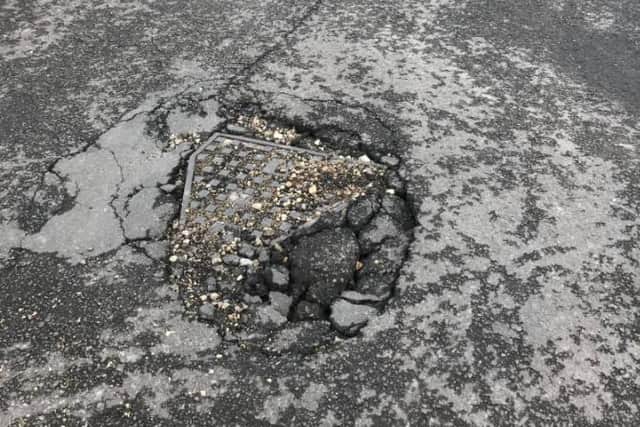 Damage to the road surface surrounding a manhole cover on Medlock Crescent, Sheffield, following flash flooding (pic: Joe Peacock)