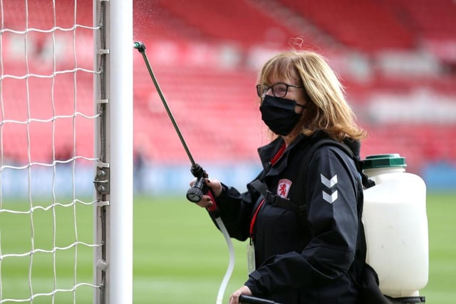 A goal post is disinfected ahead of the match.