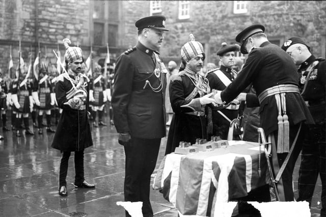 Another picture of the Edinburgh Military Tattoo in 1962. Captain Collingwood, Major Kotharala, Captain J Niven of the Canadian Black Watch and Major Ran Singh of the Sikh Regiment are presented with silver statuettes of Edinburgh Castle for their contribution.