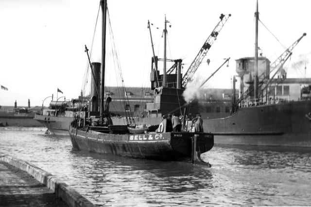 A collier tied up alongside the Camber dock, a long gone scene at the Camber, Old Portsmouth now. We can also see Nyassa the Bell & Co steam vessel registered in Cowes making her way out to the harbour. Picture: Barry Cox collection