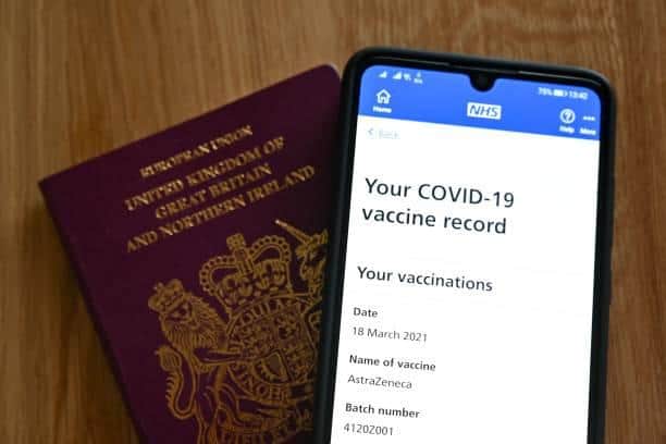 You can get an NHS Covid pass using the NHS app and proving your vaccination status or that you have reported a negative lateral flow test. Photo by JUSTIN TALLIS/AFP via Getty Images.