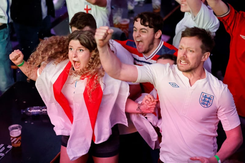 England supporters celebrate England's penalty and second goal as they watch the UEFA EURO 2020 semi-final football match between England and Denmark, at Boxpark Croydon in south London.