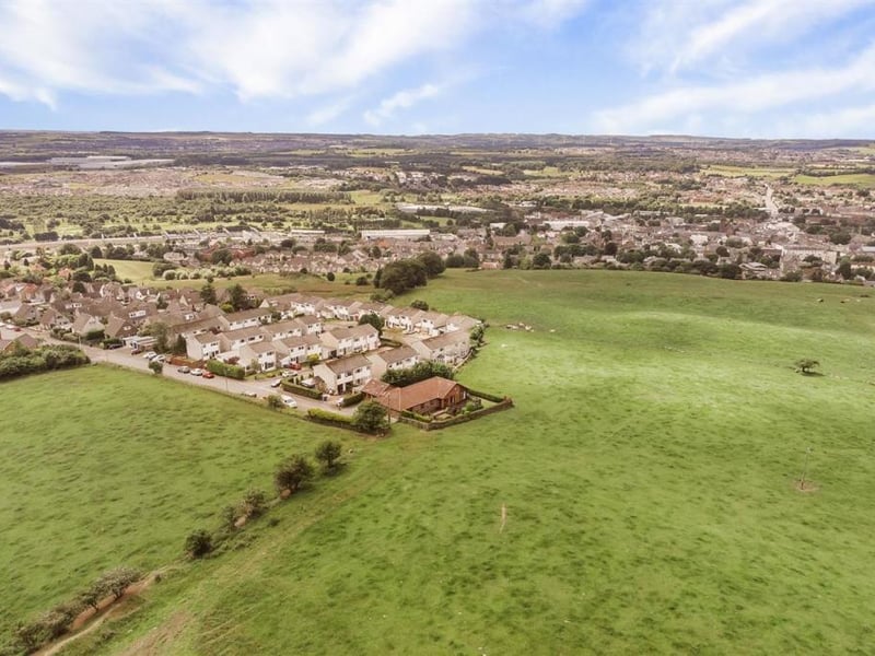 Aerial view showing property at top of the town.