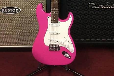 A hot pink electric guitar similar to one left in a Travelodge
