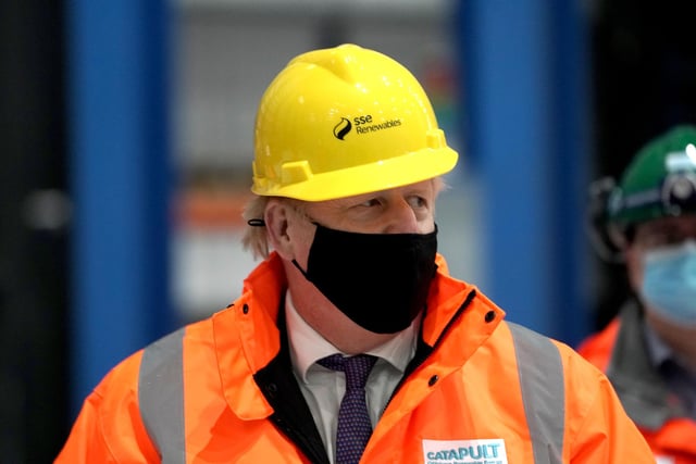 Prime Minister Boris Johnson arrives with his mask on.