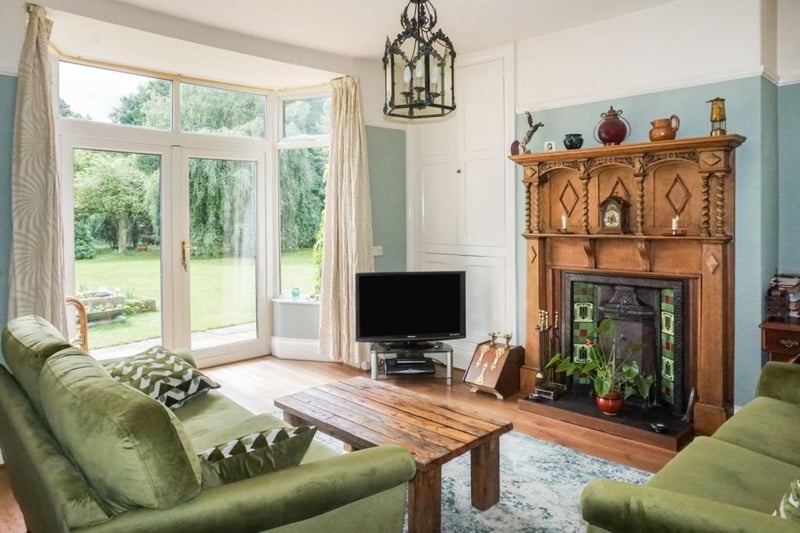 One of two reception rooms,  with feature fireplace and French doors leading to the beautiful well established gardens.