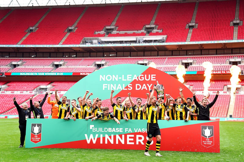 Hebburn Town's Louis Storey celebrates with team-mates and staff with the Buildbase FA Vase 2019/20 Trophy after victory in the Final at Wembley Stadium, London.