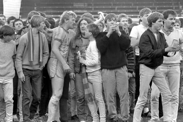 Fans invade the pitch and speak to George Foster after Stags v Colchester