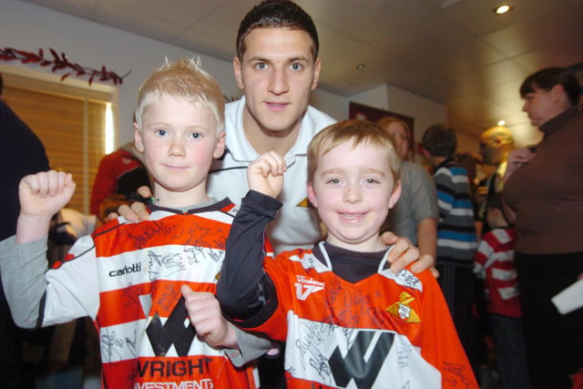 Billy Sharp meets six-year-old Toby Wainwright and seven-year-old Jack Warrener at the Junior Rovers Christmas Party in 2009