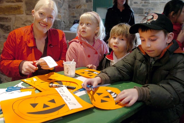 Joanna Tomkinson helps Poppy and Olivia Tomkinson and Jake Stafford make pumpkin masks at Whirlow Hall Farms Halloween Extravaganza in 2007