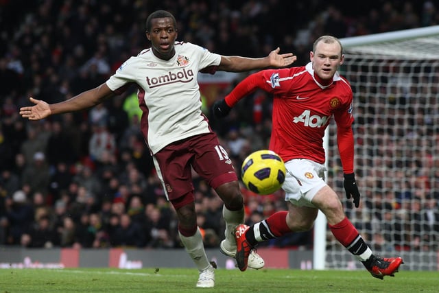 Wayne Rooney of Manchester United clashes with Nedum Ohuoha of Sunderland during a Premier League at Old Trafford on December 26, 2010.