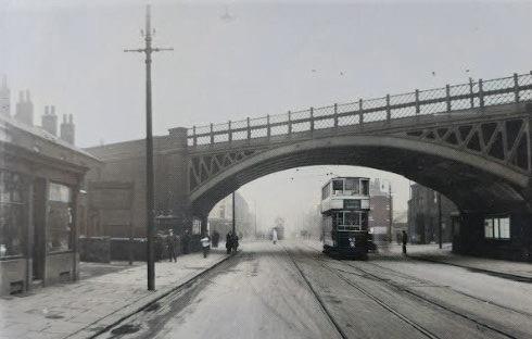 This colourised picture of a tram under Attercliffe Road railway drab makes Sheffield look grey in the late 1920s. PIcture from Sheffield Since 1900