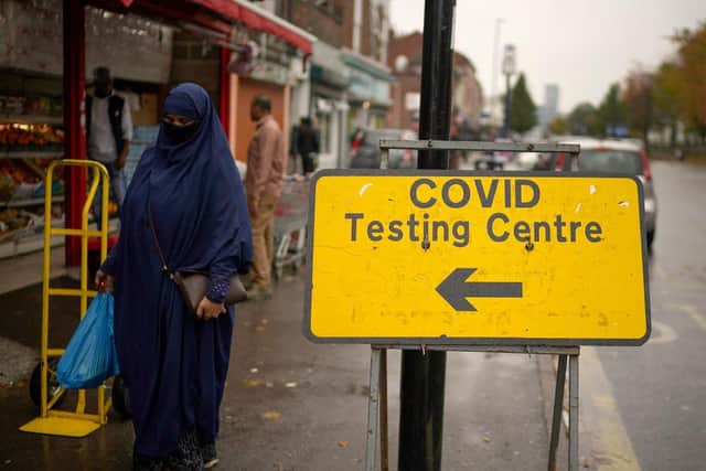 People wear face masks and PPE in Sheffield, England (Photo by Christopher Furlong/Getty Images)