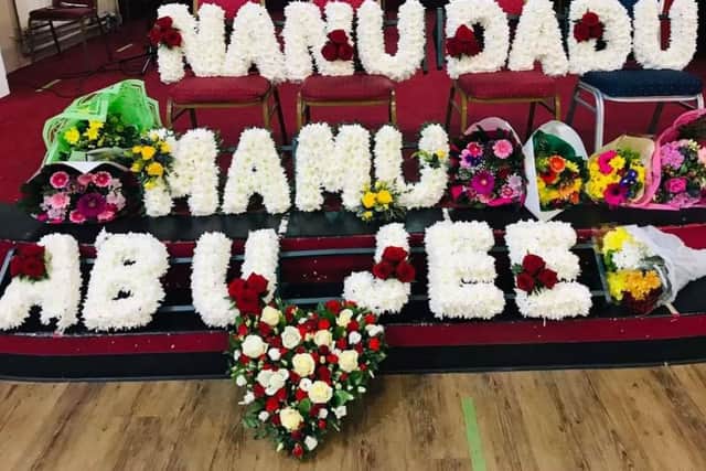 A flower arrangement at Mr Ahmed's funeral which reads: 'Grandfather, Uncle and Respected Father'.