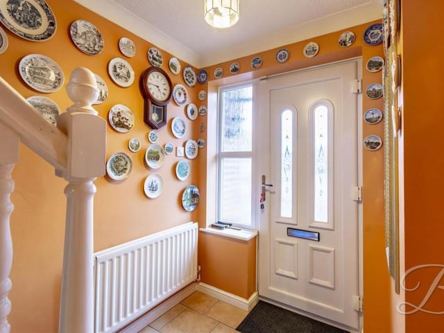 As we prepare to go upstairs, let's return to the front of the property, where the entrance hallway instantly gives visitors a warm feeling about the house.