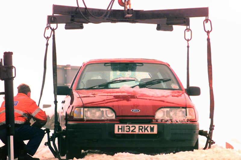 An abandoned car in a layby on the Snake Pass being recovered