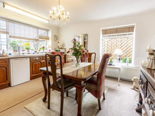 When you enter the property, an elongated hallway guides you to all the rooms on the ground floor of the bungalow. This is the elegant dining area, one part of the kitchen, which comes complete with a range of units and cabinets with work surfaces over. There is also a sink and drainer, plus space and plumbing for a dishwasher.