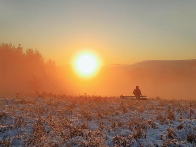 This winter sunset shot from Blaikie’s Hill was enhanced by some fog over Galashiels. Another photographer walked by and stopped at an old bench seat.