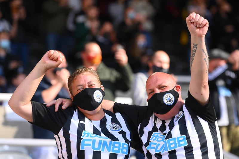 Newcastle fans wearing face-coverings react as the players enter the fray during the Premier League match between Newcastle United and Sheffield United at St. James Park