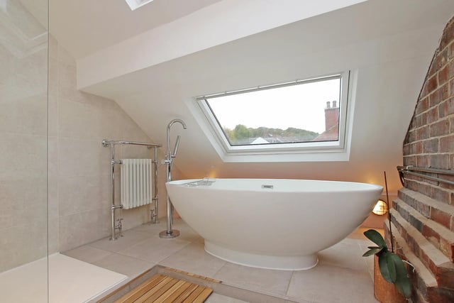 With a free standing bath and walk-in shower, this stylish bathroom looks great.
