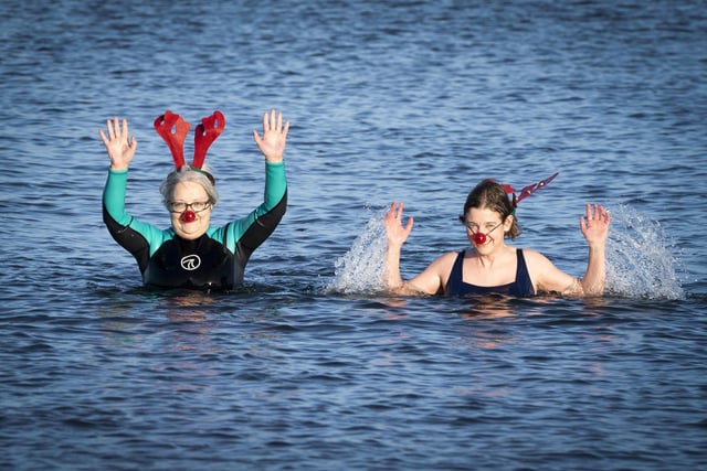 People swim and take a dip in the Firth of Forth at Portobello Beach in Edinburgh on New Year's Day. Picture date: Saturday January 1, 2022. PA Photo. Photo credit should read: Jane Barlow/PA Wire
