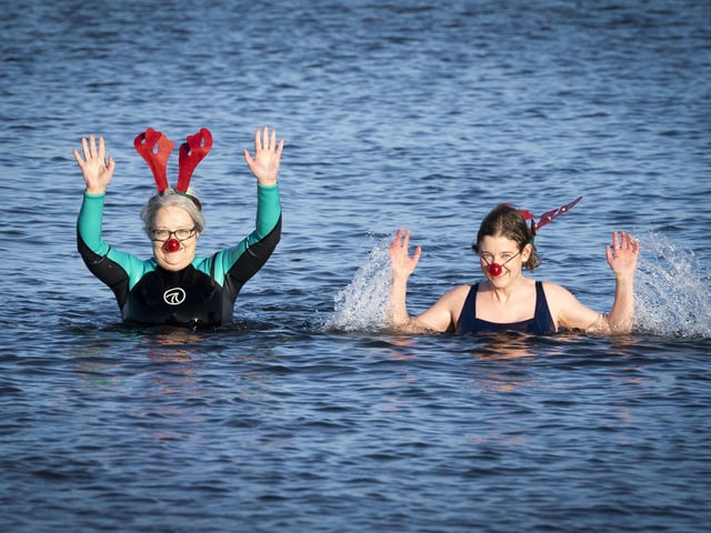 People swim and take a dip in the Firth of Forth at Portobello Beach in Edinburgh on New Year's Day. Picture date: Saturday January 1, 2022. PA Photo. Photo credit should read: Jane Barlow/PA Wire