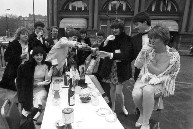 Students having a champagne breakfast opposite the Caledonian Hotel in Princes Street in aid of Edinburgh University Charities Week, April 1983.