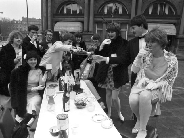 Students having a champagne breakfast opposite the Caledonian Hotel in Princes Street in aid of Edinburgh University Charities Week, April 1983.