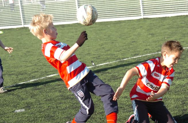 Ewan Calam and Owen Hall both aged eight. Playing football.