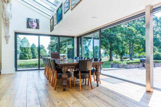 The full length sliding doors make the most of the two acre mature grounds the house sits in.