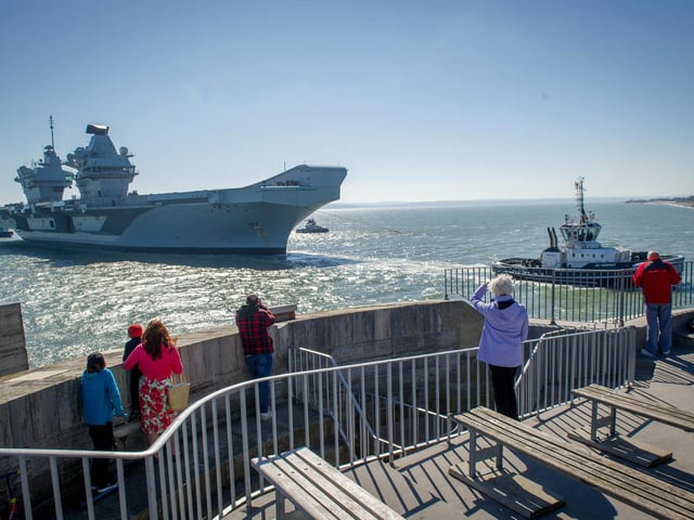 Handful of people watch HMS Prince of Wales returning home from the Round Tower