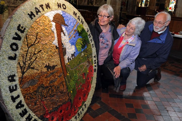Wirksworth Blessing of the wells in 2014, pictured are Nolleen Lumbley, left and Heather and John Neaum in St. Mary's Church.
