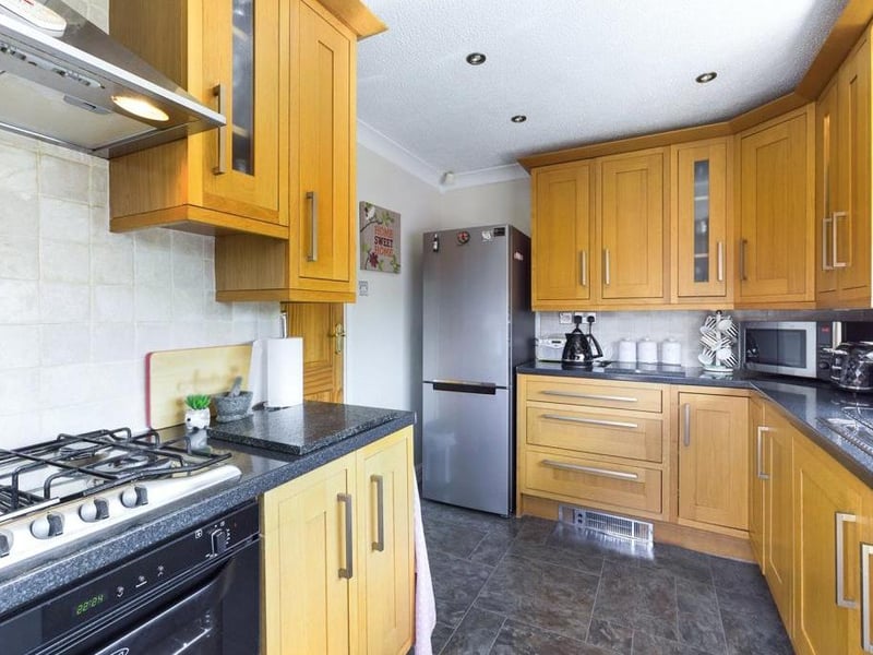 Kitchen with a range of high quality oak wall and base units, complementary work-surfaces, inset sink, mixer tap, tiled splash-backs, gas hob, extractor hood, integrated double oven and grill, plumbing for dishwasher and automatic washing machine, Karndean flooring, electric plinth heater, power points and uPVC double glazed exterior side entry door.