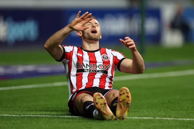 Rhys Norrington-Davies of Sheffield United lies injured during their Sky Bet Championship with Coventry City: Catherine Ivill/Getty Images
