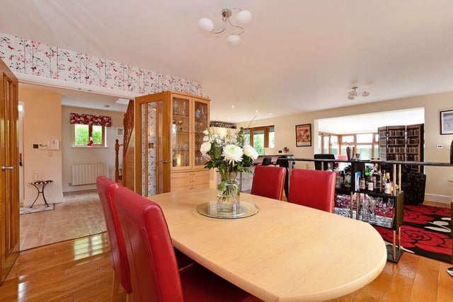 The spacious open plan living room contains a lounge and dining area, leading into both the conservatory and the kitchen.