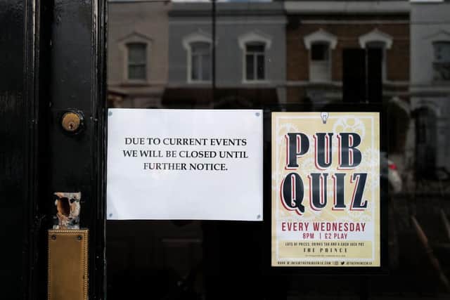 A sign is displayed on the door of a closed pub on March 21, 2020 in London, England.  (Photo by Julian Finney/Getty Images)
