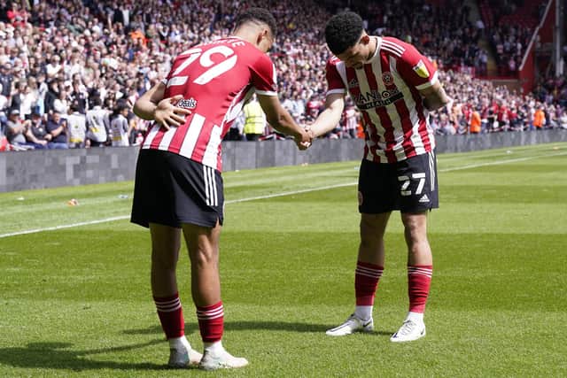Sheffield United's Iliman Ndiaye (right) celebrates scoring their side's second goal of the game with team-mate Morgan Gibbs-White during the win over Fulham: Danny Lawson/PA Wire.