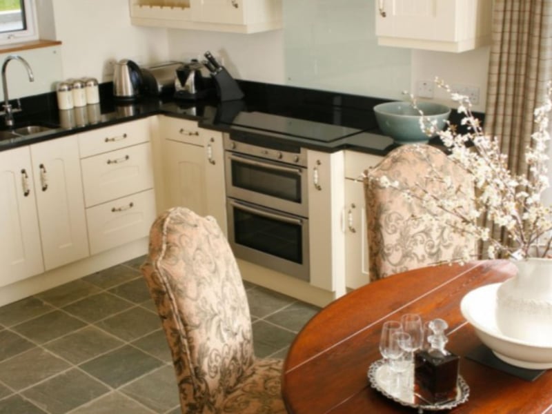 The stylish white kitchen also has a dining area.