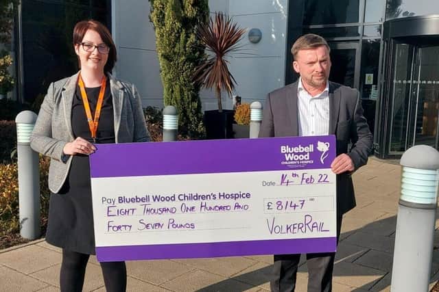 Stuart Webster-Spriggs, VolkerRail’s HSQES director, presents a cheque for a portion of the company's recent donation to Bluebell Wood’s Regional Fundraiser Eleanor Hughes
