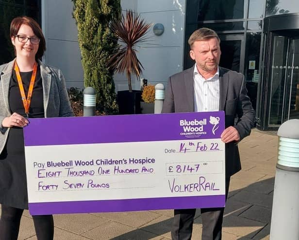 Stuart Webster-Spriggs, VolkerRail’s HSQES director, presents a cheque for a portion of the company's recent donation to Bluebell Wood’s Regional Fundraiser Eleanor Hughes
