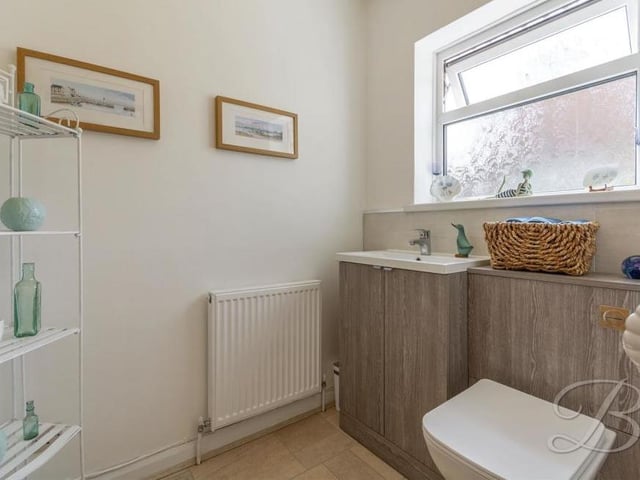 Even the downstairs toilet has a touch of style about it. Off the hallway, it comes complete with a low-flush WC, vanity unit and central-heating radiator.