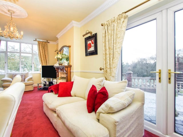 UPVC bay window to front, UPVC French doors leading to the rear, feature Adams style fire surround with decorative tiled and gas fire, picture rail and radiator.