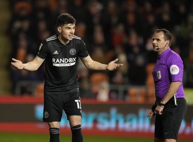 John Egan of Sheffield United questions the offside goal decision at Blackpool with referee Geoff Eltringham: Andrew Yates / Sportimage