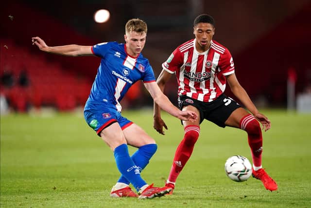 Sheffield United's Daniel Jebbison (right) and Carlisle United's George Tanner battle for the ball during the Carabao Cup first round match at Bramall Lane, Sheffield. Picture date: Tuesday August 10, 2021. PA Photo. See PA story SOCCER Sheff Utd. Photo credit should read: Zac Goodwin/PA Wire.