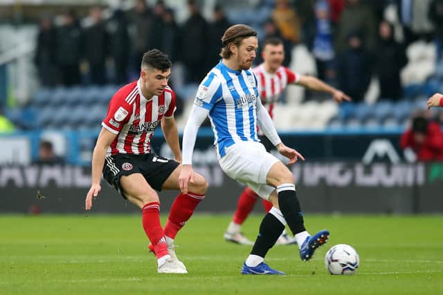 Defender John Egan of Sheffield United in action with Danny Ward of Huddersfield Town during the Sky Bet Championship match at the John Smith's Stadium, Huddersfield: Simon Bellis / Sportimage