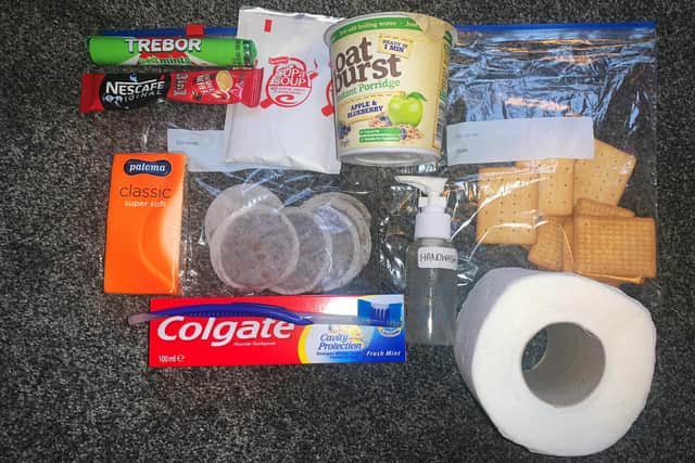 The care packages have items such as toilet roll, tea bags, and porridge