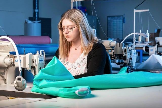 John Lewis has started making about 8,000 washable, clinical gowns for Northumbria Healthcare NHS Foundation Trust, at a site in Lancashire.