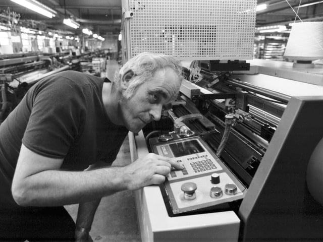 A worker using a Scheller bar filling machine at the Pringle knitwear factory in Hawick, December 1985.